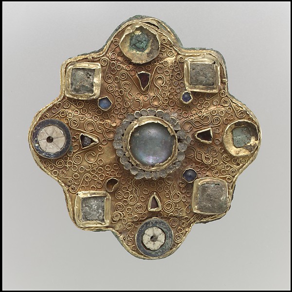 A charming sapphire and diamond 'Mystery Set' clip brooch in the form of a flower.